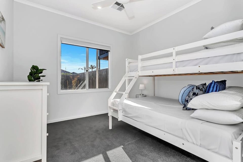 Unwind in the third bedroom, featuring a bunk with a double bed below and a single above, ideal for families or friends sharing.