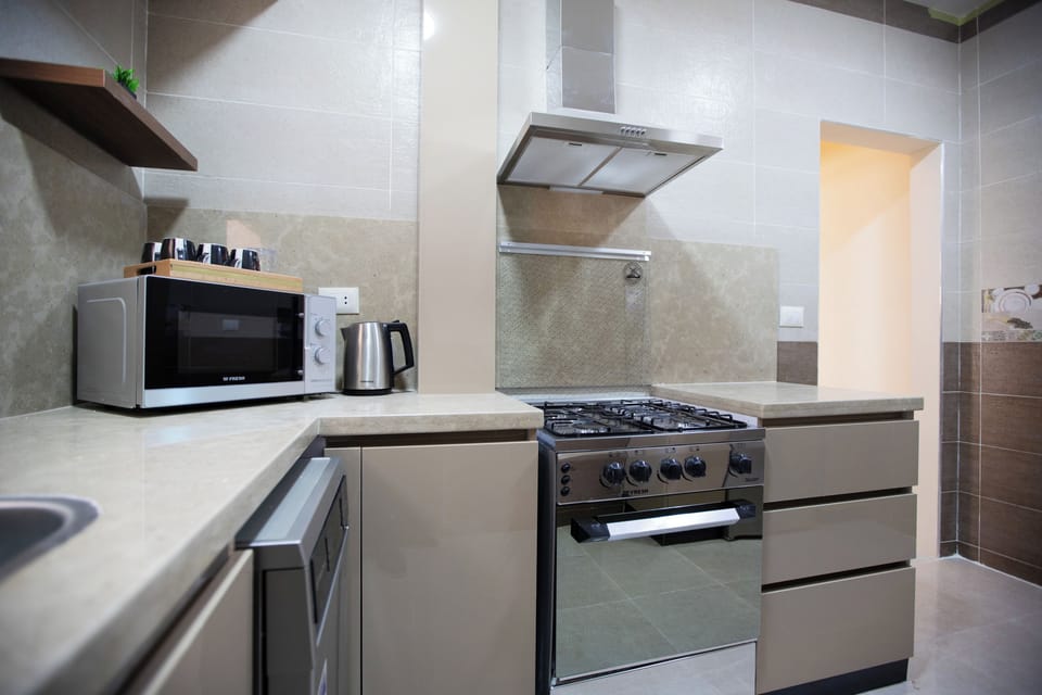 Deluxe Apartment, 3 Bedrooms, Balcony, City View | Private kitchen | Full-size fridge, microwave, oven, stovetop