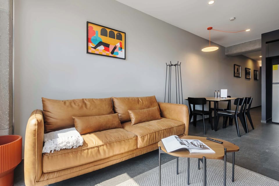 Spacious living room with warm tones and modern decor.

