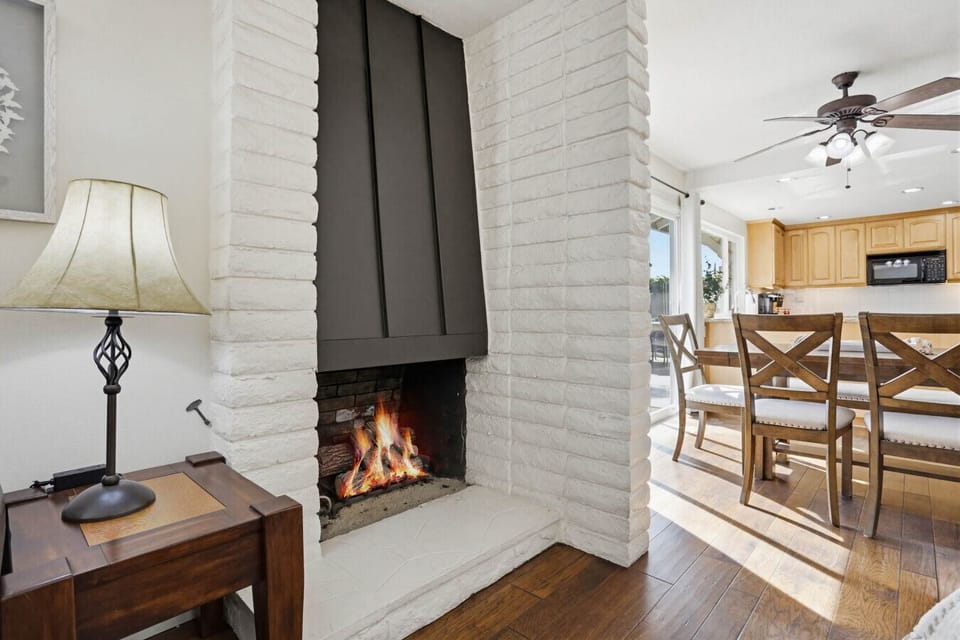 Cozy fireplace nook w/ brick surround & warm glow, perfect for relaxing evenings indoors