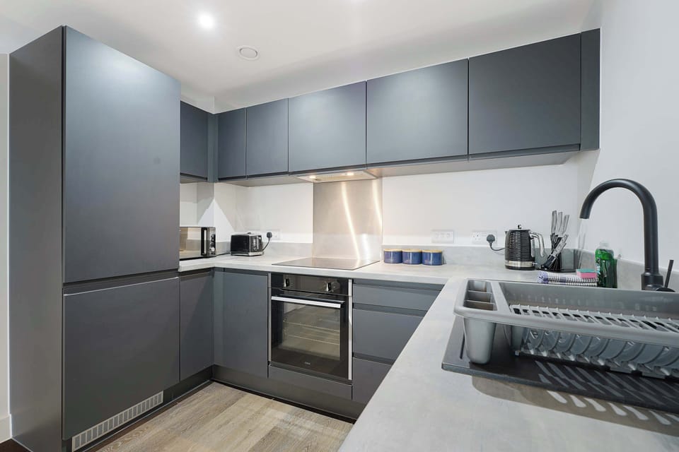 A modern, fully equipped kitchen with sleek finishes and all the essentials you need to prepare home-cooked meals with ease during your stay.
