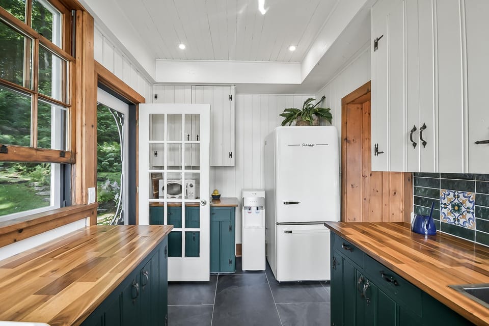 Bright kitchen with wooden countertops and garden views