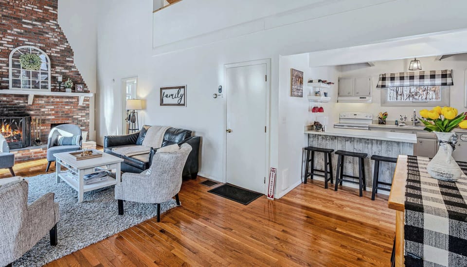 Open layout from dining area into living room with breakfast bar seating