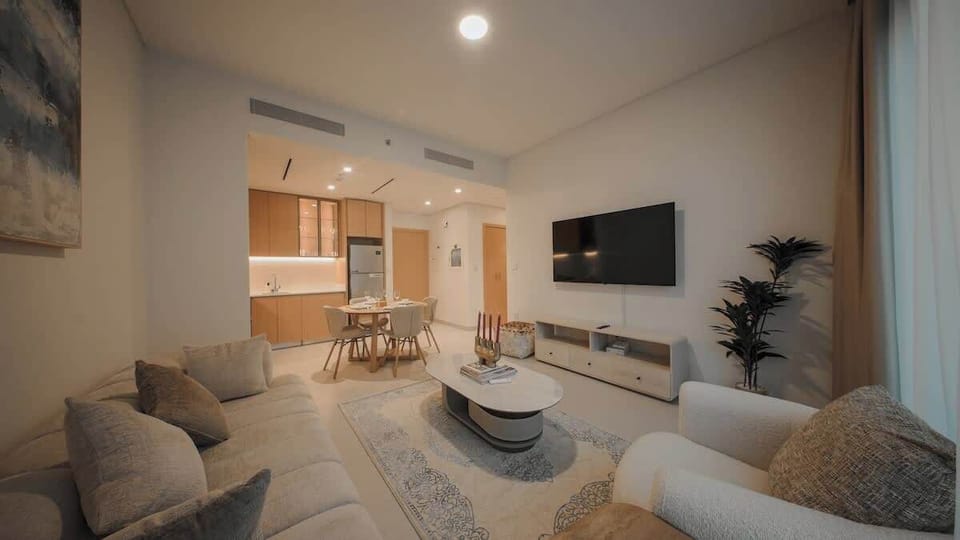 Bright living area with comfortable seating and Smart TV