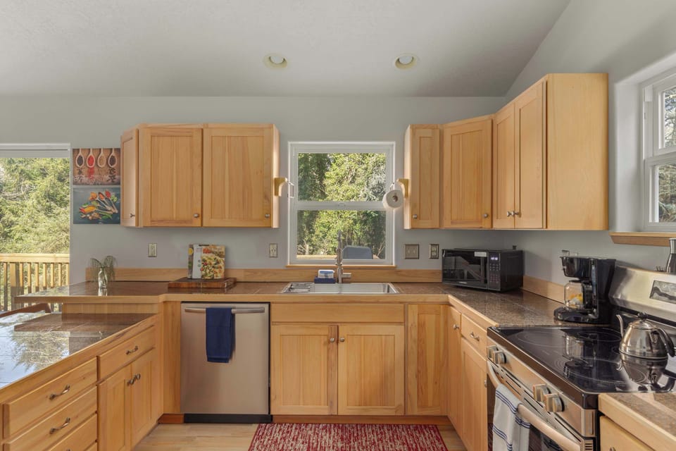 Light-filled kitchen with storage, workspace & everything needed for your stay.