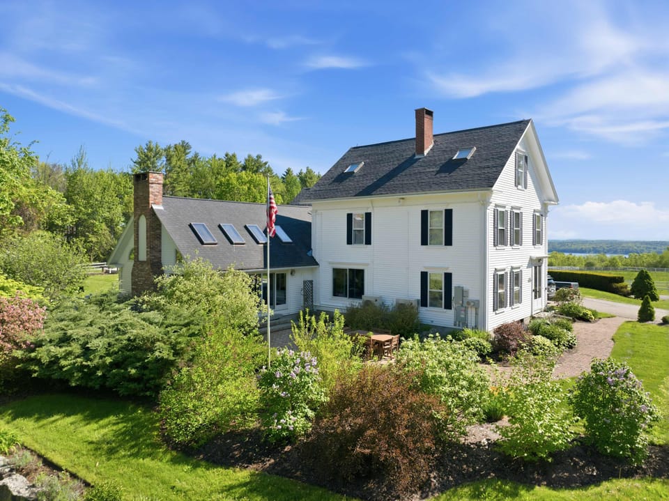 Classic New England charm meets elevated country living, featuring beautifully maintained landscaping, timeless architecture, and scenic lake and mountain views from the property