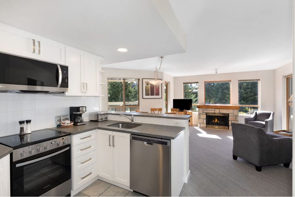 Gather for cozy meals beside the warm fireplace glow.