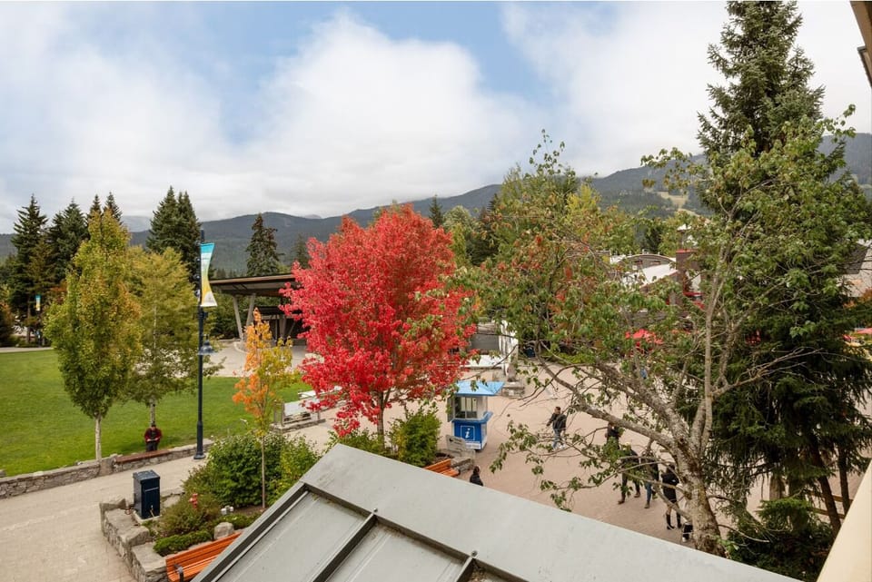 Explore the vibrant village below with mountains rising beyond.