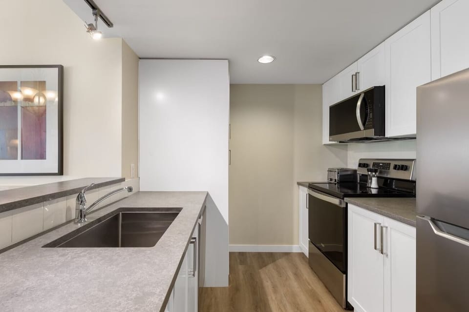 Prep meals comfortably with bright lighting and ample workspace.