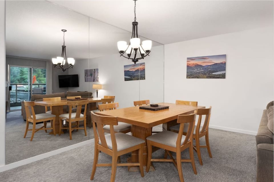 Host lively dinners at the spacious table with mirrored light.