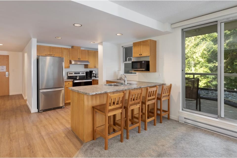 Cook and connect around the breakfast bar with forest light.