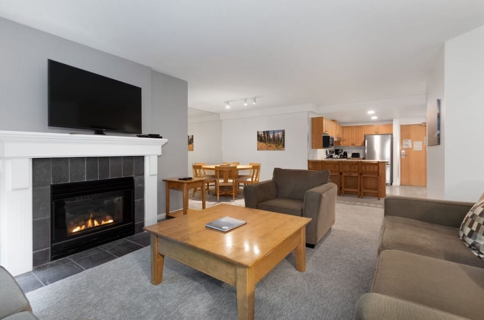 Cozy up by the glowing fireplace after a day out.