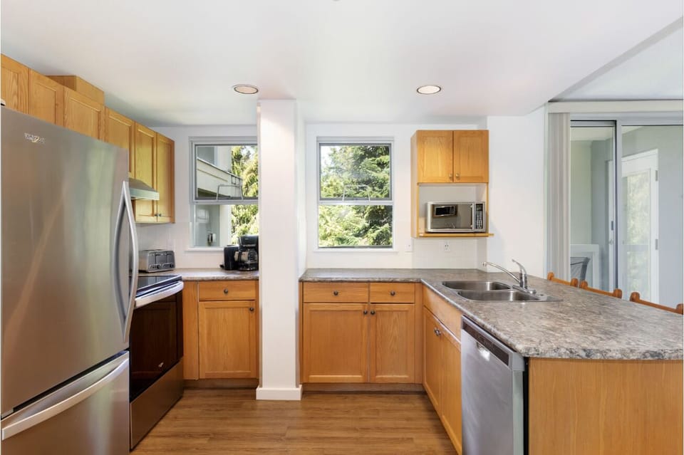 Prep comfortably with generous counters, bright windows, and storage.