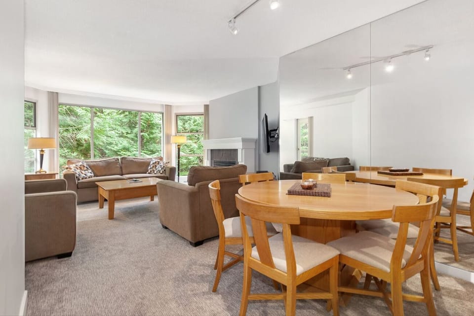 Sip wine at the table while the living room glows.