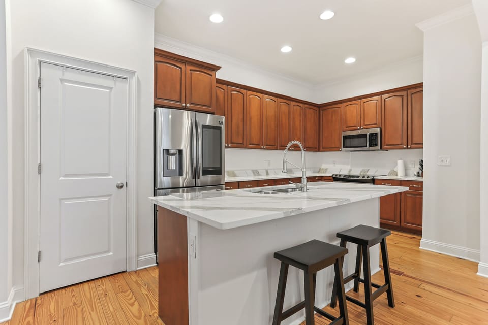 The open kitchen features a spacious island, modern appliances, and plenty of room to cook, gather, and enjoy meals together.