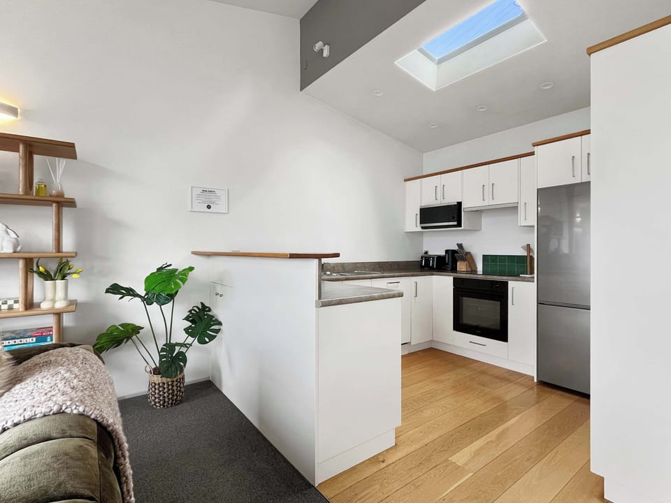 Modern kitchen with skylight and full appliances