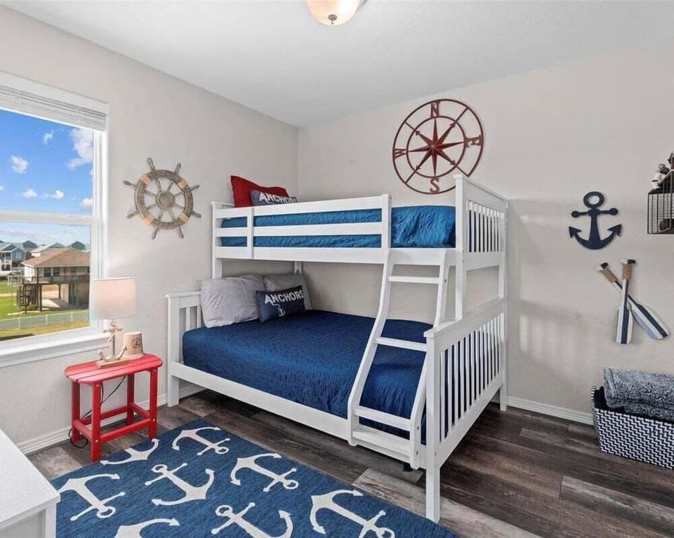 Fun bunk room perfect for kids featuring nautical décor and multiple sleeping spaces.