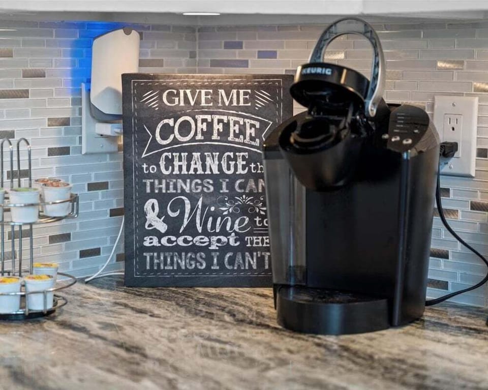 Coffee station with Keurig machine and coastal décor, perfect for starting your morning during your Galveston vacation.