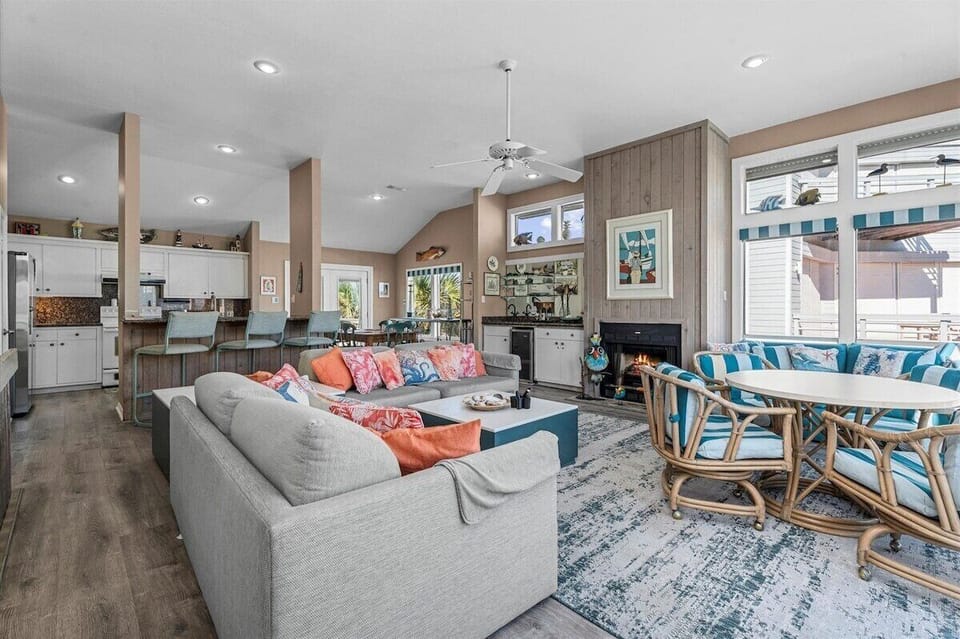 Open living and dining layout with coastal furnishings and spacious seating. Ideal for entertaining, family gatherings, and extended beach vacations.
