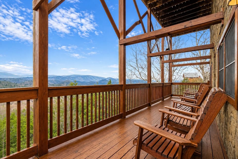 Covered mountain-view deck with rocking chairs and peaceful Smoky Mountain scenery at private Sevierville cabin rental.
