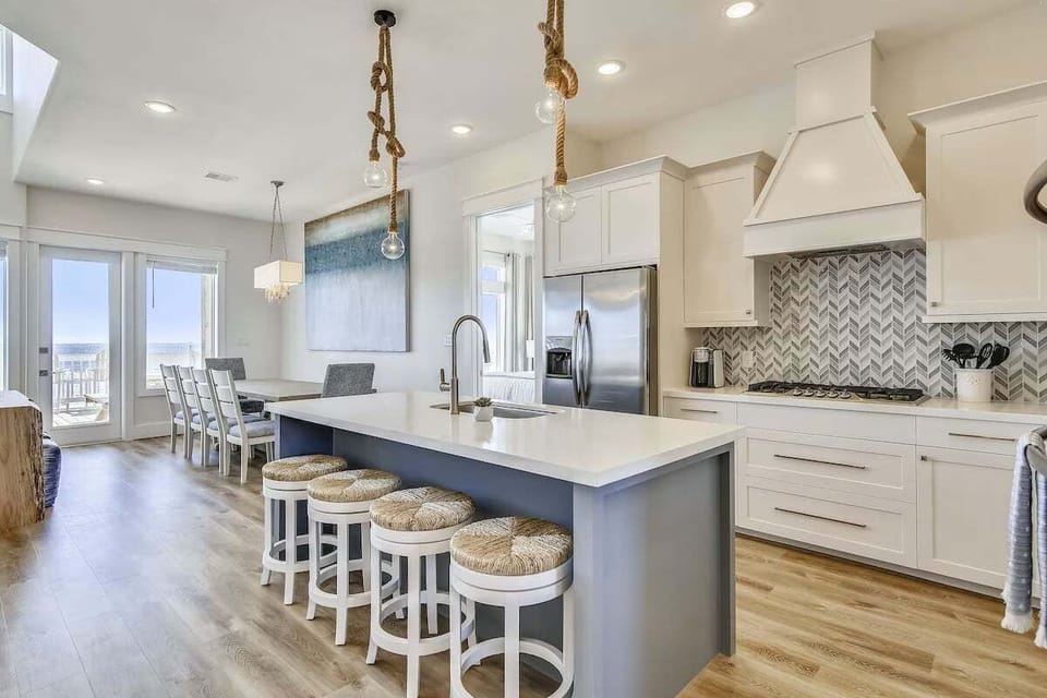 Gourmet kitchen with large island, bar seating, stainless steel appliances, and custom cabinetry.