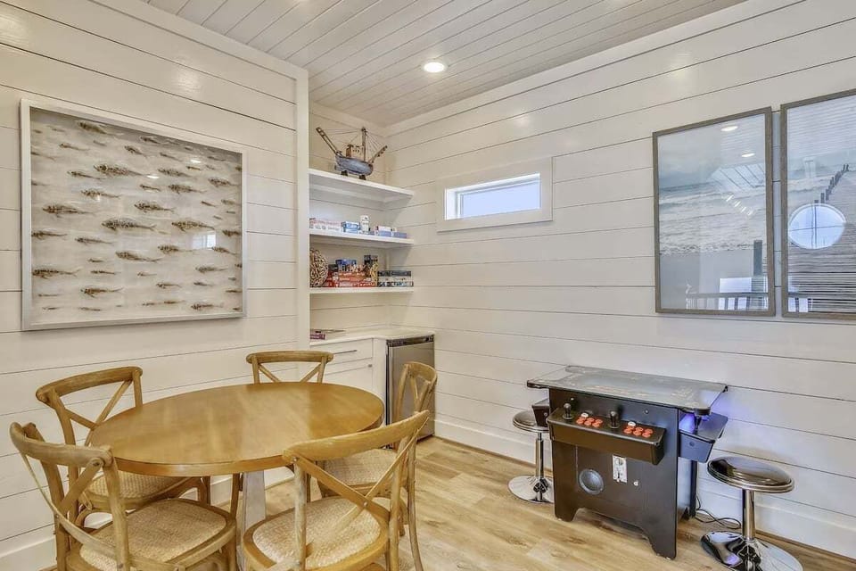 Cozy game room with an arcade game and board games for families to gather and enjoy.