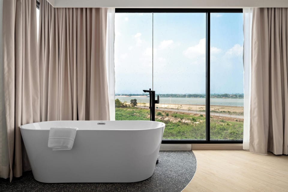 Premier Suite, River View | Bathroom | Hair dryer, slippers, towels, soap