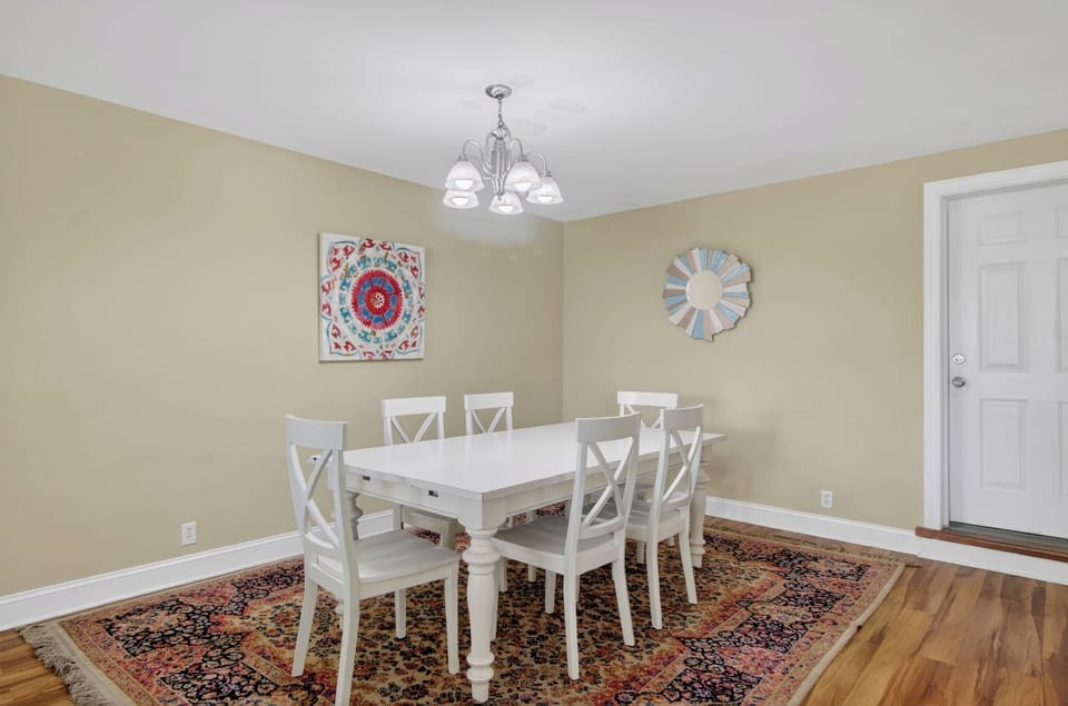 Gather for meals and game nights at the bright dining table with seating for six.