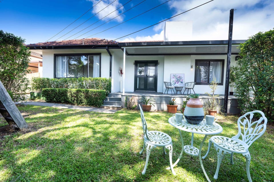 Relax in this charming, sunlit home featuring a cosy outdoor garden perfect for morning coffee or evening unwinding. With a welcoming porch, lush greenery, & comfortable seating, this peaceful retreat offers the ideal blend of comfort & tranquilly.