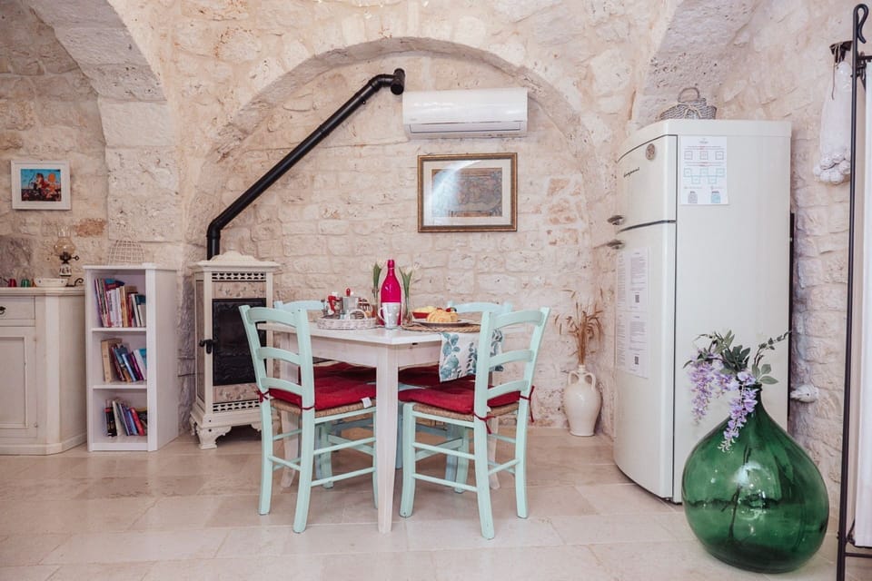Furniture, Interior Design, Chair, Table, Flooring, Kitchen & Dining Room Table, Apartment, Dining Room, Ceiling, Stone Wall
