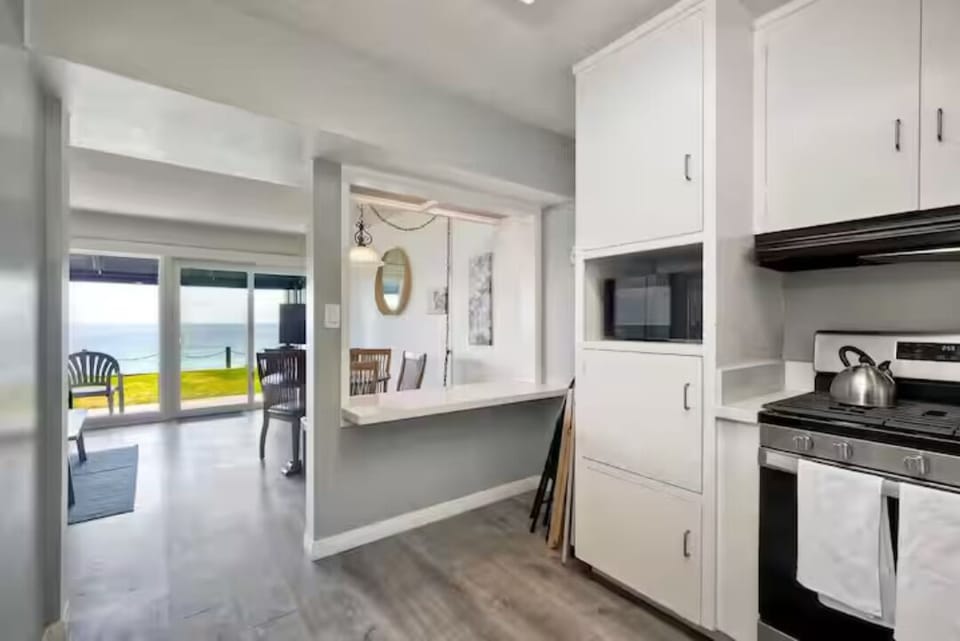 Cook in style while enjoying the open-concept layout that overlooks the dining area and the sparkling ocean. Bright and airy, this space is perfect for meals, gatherings, or simply soaking in the relaxing beach vibes.