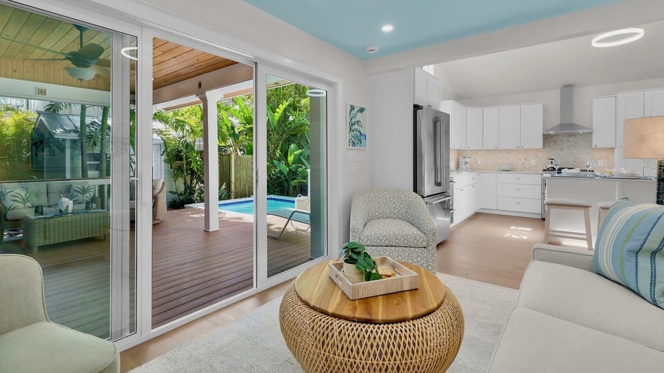 The living room flows seamlessly to the covered deck and pool area...