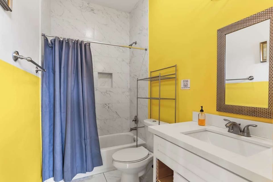 Freshly updated bathroom with a tub/shower combo, modern vanity, and clean finishes. Bright, functional space stocked with fresh towels and essentials for a comfortable stay.