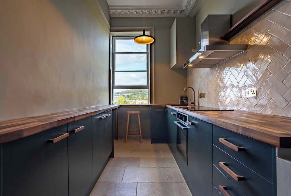 Stylish and well equipped kitchen with espresso maker, bronze fittings, breakfast bar with views and dishwasher