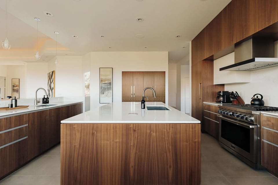 Your spacious chef's kitchen features premium appliances, sleek white countertops, and warm wood cabinetry for memorable meal preparation.