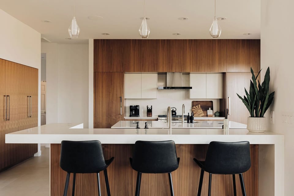 Your sleek modern kitchen features a stunning island where you can enjoy morning coffee with friends.