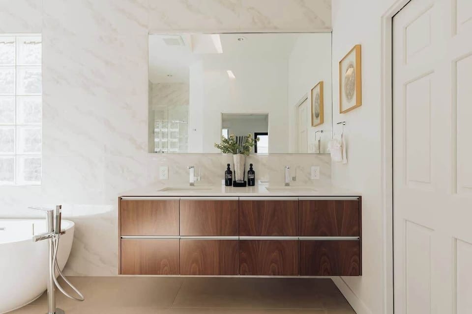 Step into your serene spa-like bathroom, where elegant walnut vanity meets pristine white marble for ultimate relaxation.