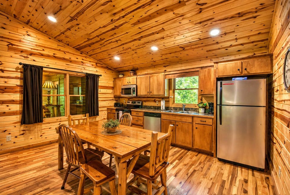 Cozy cabin dining meets a fully equipped kitchen—warm wood tones, vaulted ceilings, and the perfect space to gather, cook, and unwind.