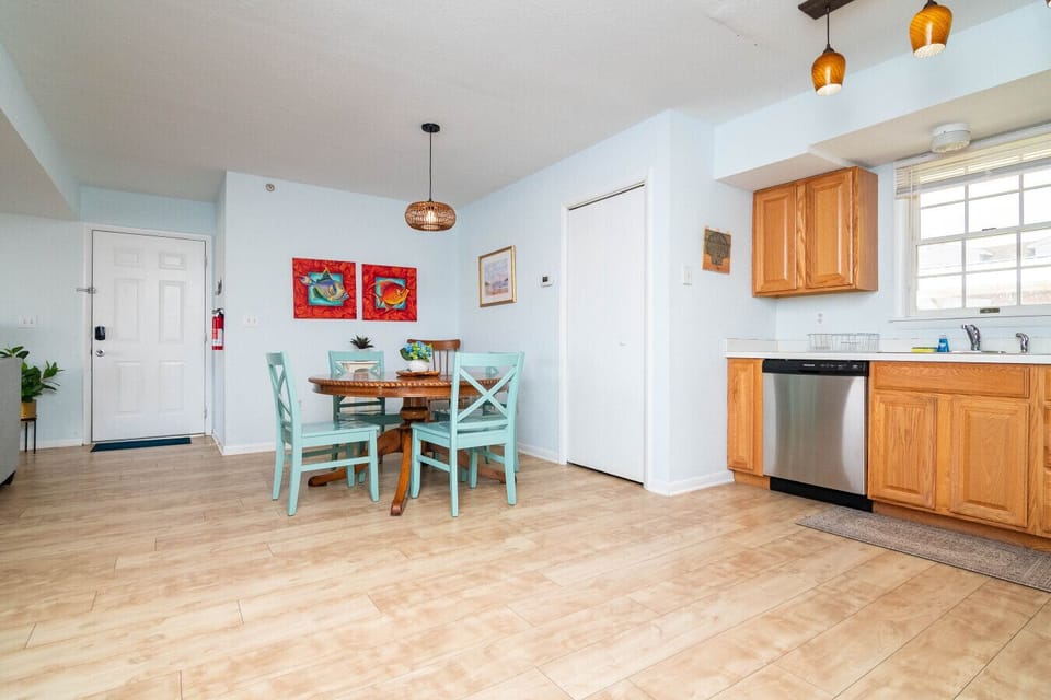 Cozy dining space with a round four-seater table, ideal for enjoying meals, morning coffee, or planning your day at the beach.