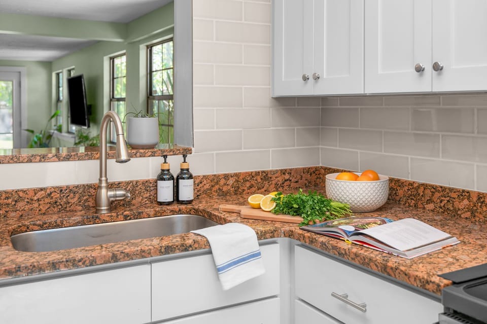 Bright dining area with seating for shared meals, complemented by a fully equipped kitchen complete with essential utensils, cookware, and appliances—perfect for easy meal prep and comfortable group dining