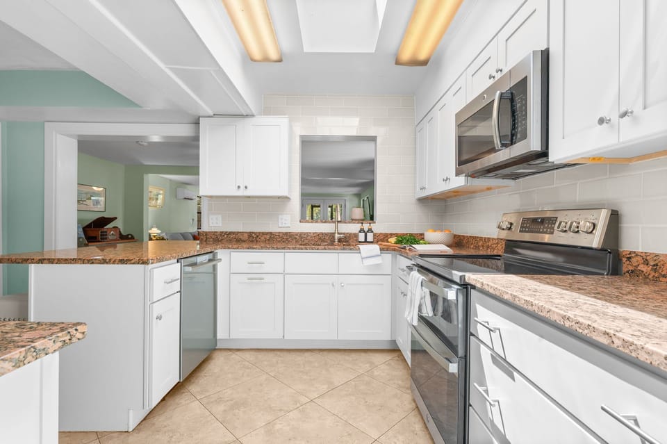 Bright dining area with seating for shared meals, complemented by a fully equipped kitchen complete with essential utensils, cookware, and appliances—perfect for easy meal prep and comfortable group dining