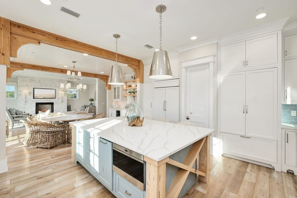 Your gourmet kitchen awaits with marble countertops, custom cabinetry, and warm wood beams creating the perfect space for cooking memorable meals.