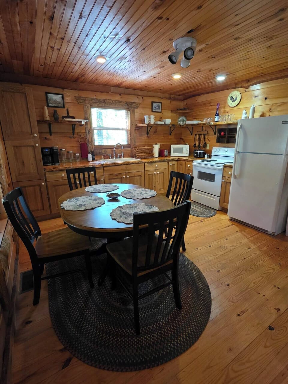 Full size kitchen with full size refrigerator, range and deep sink