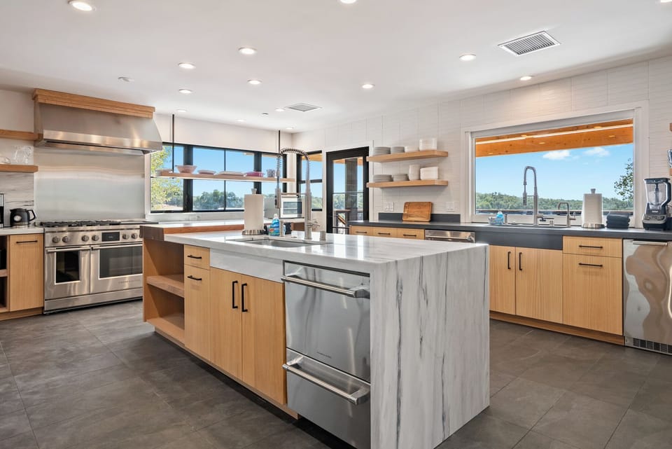 An expansive gourmet kitchen with industrial luxury, a dual-sink layout, and a spacious island for effortless prep.