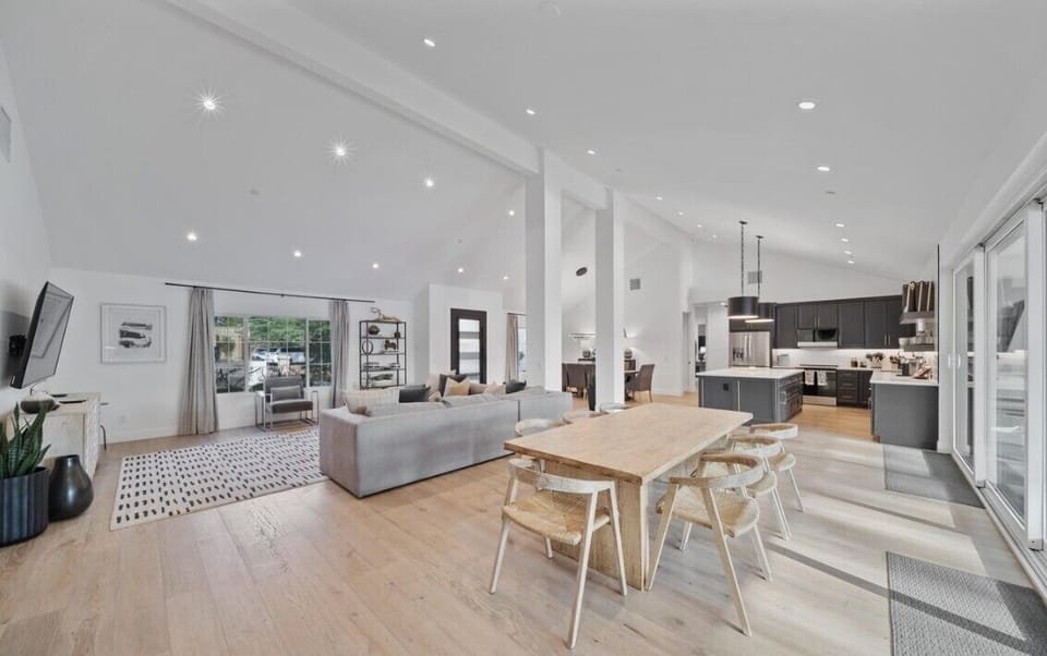 Soaring ceilings and light oak floors highlight the kitchen and dining