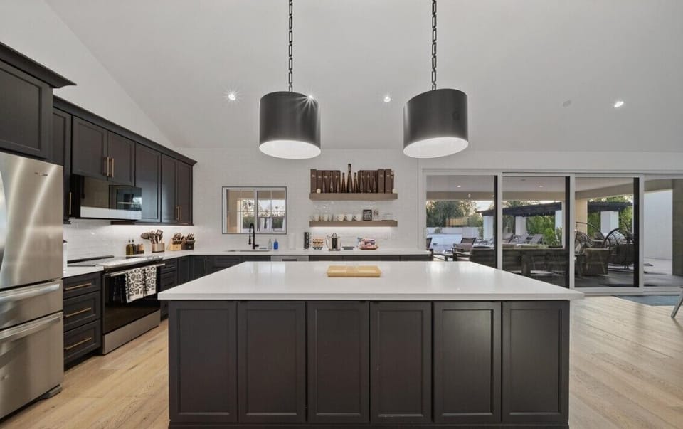 Gourmet kitchen, oak dining, and lounge with sectional in stylish Great Room