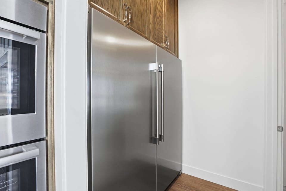 Modern White Kitchen With A Spacious Fridge
