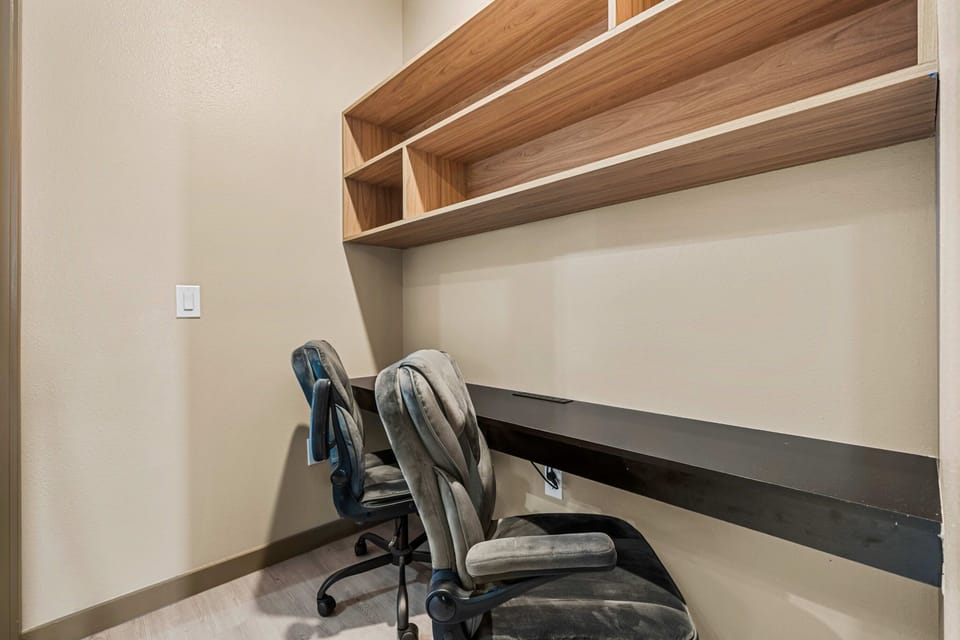 Cozy workspace with dual chairs and wooden shelving for organization