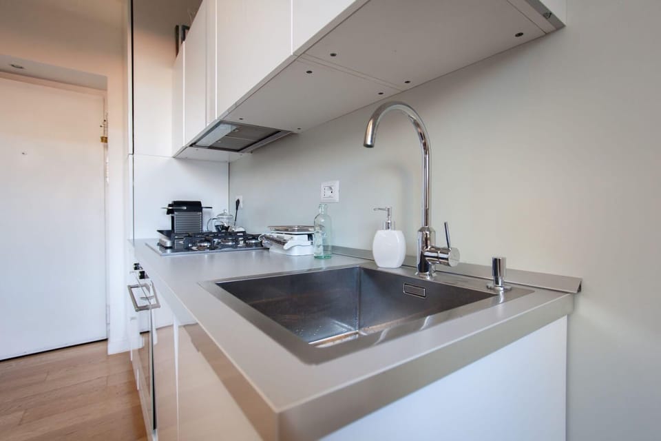 Modern compact kitchen with sleek finishes and integrated appliances.