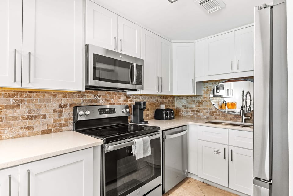 Modern fully equipped kitchen in gulf front 30A townhome design. 